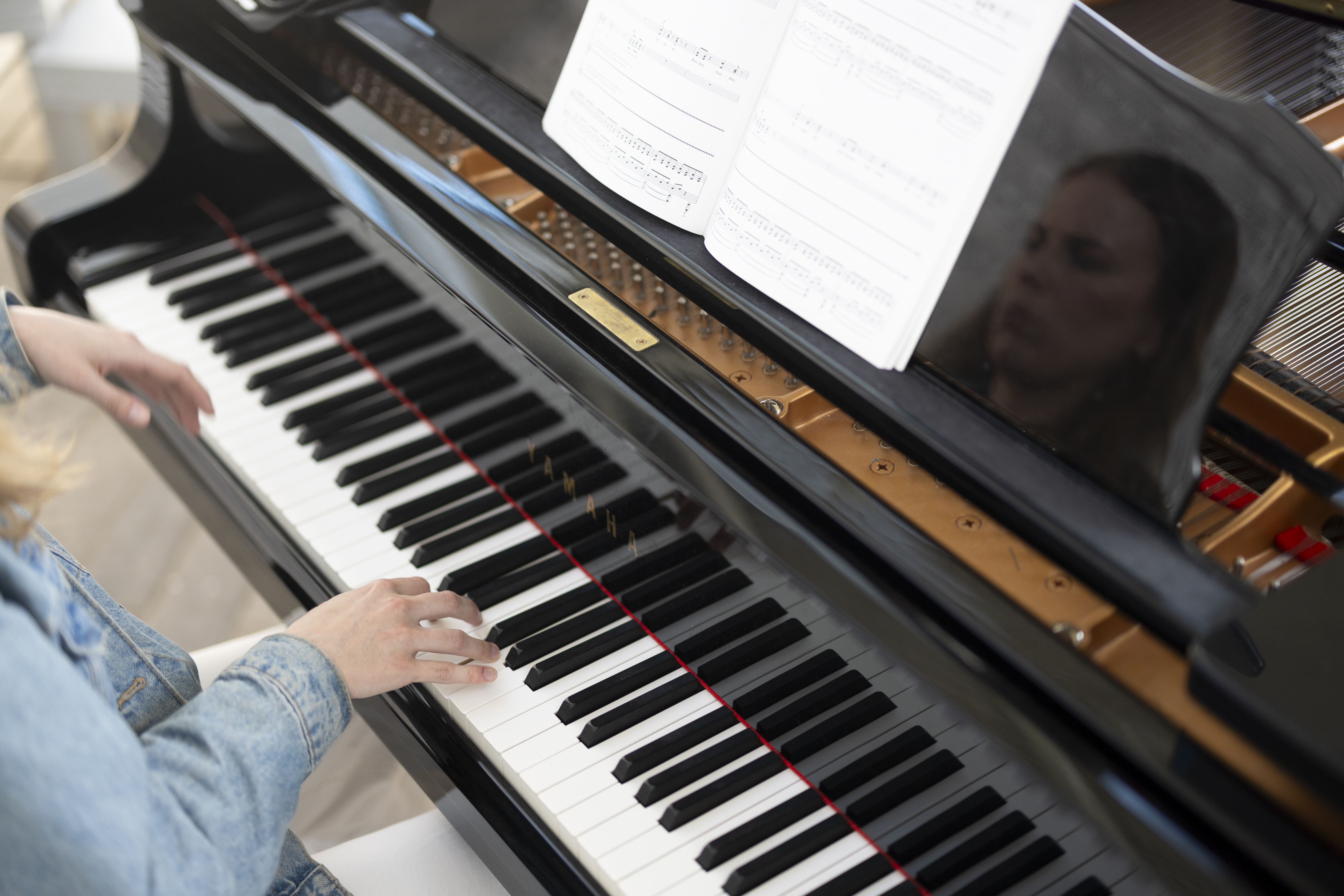 En person spelar på flygeln i Årsta kyrka